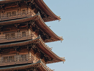 Fototapeta premium Chinese traditional eaves. The eaves of traditional temples. Beautiful Chinese traditional eaves. Close up view of Tang dynasty style pagoda, wooden structure.