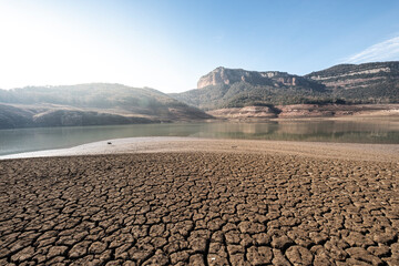 Desolate landscape of dry and broken land in the Sau reservoir, Panta de Sau, due to the greatest drought in Catalonia in history