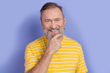Portrait of toothy beaming good mood pensioner persone wear yellow t-shirt touching white gray...