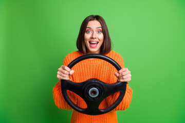 Photo of astonished funky person arms hold steering wheel open mouth isolated on green color background