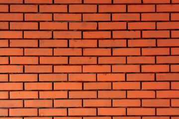Fototapeta premium Orange red horizontal brick wall. Old textured surface background or cover element. Web banner.