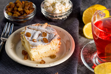 Homemade cheesecake with raisins. Pieces of cheesecake with raisins and lemon slices and tea