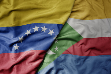 Fototapeta premium big waving national colorful flag of comoros and national flag of venezuela . macro