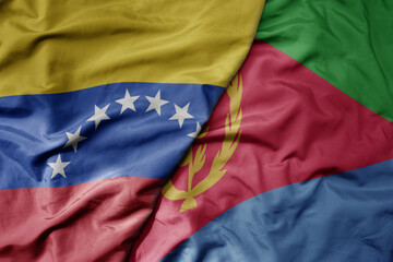 Fototapeta premium big waving national colorful flag of eritrea and national flag of venezuela . macro