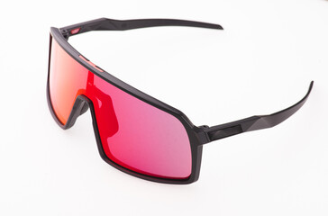 Black sports glasses on white background. Side view. Space for text.