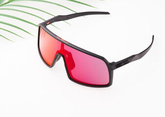 Black sports glasses on white background. Side view. Space for text.