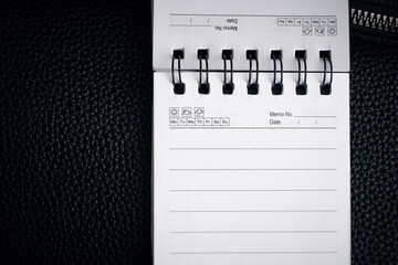 A notebook with springs on a black background. Empty notebook, stock photo
