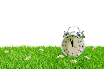 Alarm clock on a meadow in the grass. Daylight saving transitional change of season. 3d rendering