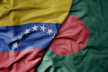 Fototapeta premium big waving national colorful flag of bangladesh and national flag of venezuela . macro