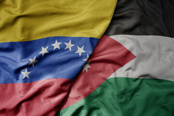 big waving national colorful flag of jordan and national flag of venezuela . macro