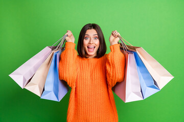 Photo of impressed nice girl hands hold raise shop bags limited time only sale offer isolated on...