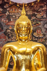 Awesome view of gilded Buddha statue among amazing murals