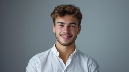 A man in a white shirt smiles at the camera. Perfect for business and professional concepts