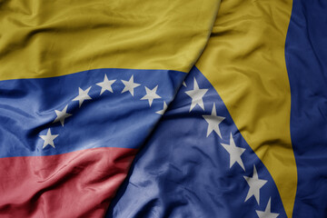 big waving national colorful flag of bosnia and herzegovina and national flag of venezuela . macro