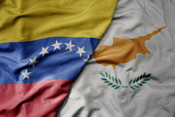 big waving national colorful flag of cyprus and national flag of venezuela . macro