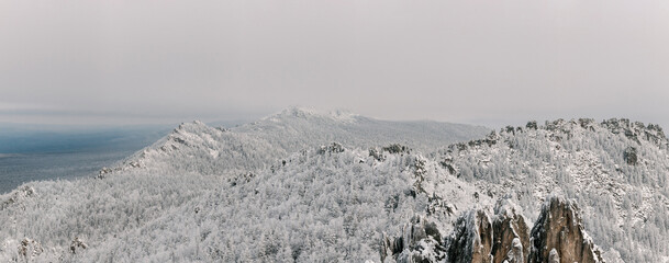 Ural mountains in winter. Wonderful wintry landscape at sunny day. Amazing view on snow covered mountains and white spruces.