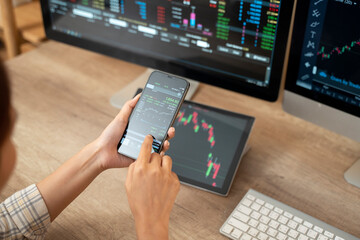 Woman is checking Bitcoin price chart on digital exchange on smartphone, cryptocurrency future price action prediction. - 726436150