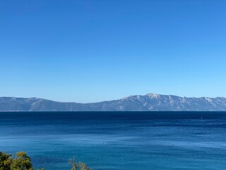 blue maybe green trees on shore, island in Croatia visible in distance