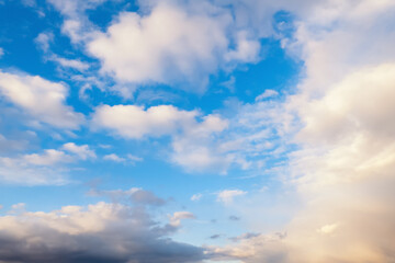 Natural background blue sky with light clouds in sunlight