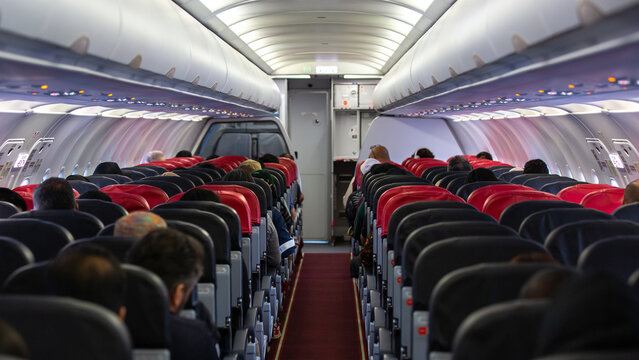 Passengers traveling by a plane, shot from the inside of an airplane