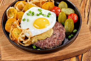 baked potatoes with cultet and fried egg
