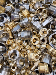 Various sized brass fittings in a random heap. Used in plumbing and gas installations
