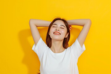 Fototapeta premium Asian woman wearing a white blank t shirt on a bold yellow background, mockup