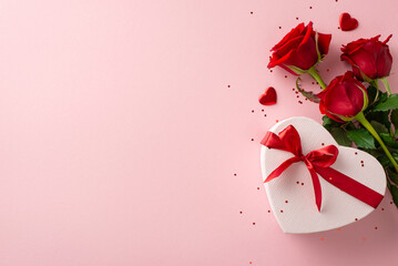 Luxurious women's gift concept: Top-down view of sophisticated rose arrangement, fashionable heart shaped gift box, and glitter on pastel pink background, with space for words or promotion