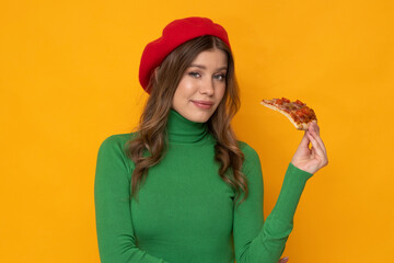 Beautiful young woman with pizza on isolated orange background.