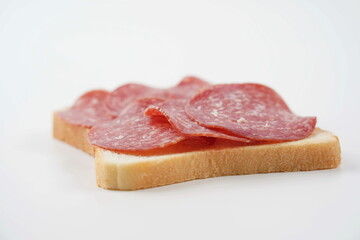 Salami sandwich. Open sandwich of salami slices, thin cut. Spanish salami with spices on  bread.
