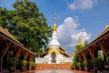 White and gold pagoda of Buddhist temple under blue sky and clouds as background, Wat Phra That Doi...