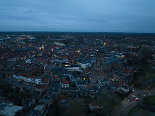 Aerial overview at dusk of the city of Zutphen, along the river Ijssel in Gelderland, The Netherlands. Birds eye aerial drone view in the Dutch province of Gelderland.