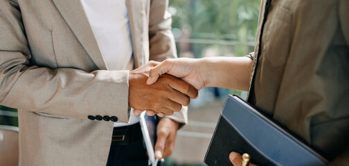 Two confident business man shaking hands during a meeting in the office, success, dealing, greeting...