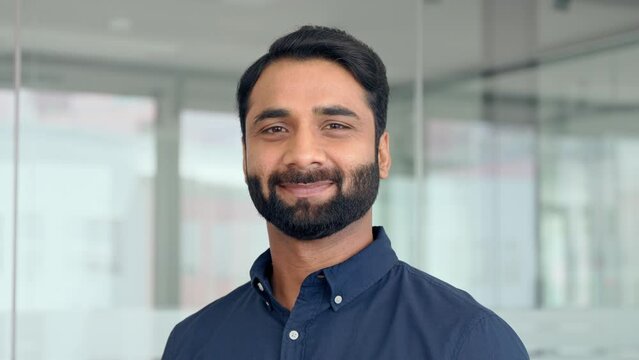 Confident Indian business man lawyer, professional businessman manager in office, corporate executive, handsome leader, male employee from India looking at camera, headshot close up face portrait.