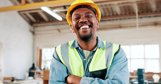 Face, engineer and happy black man with arms crossed in woodwork workshop. Portrait, smile and confidence of professional architect, contractor or worker in helmet at factory for carpentry in Nigeria