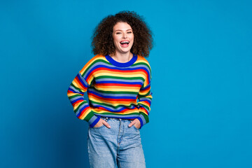 Photo portrait of pretty young girl laugh posing new trousers dressed stylish rainbow print outfit isolated on blue color background