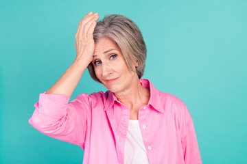 Portrait of minded grandmother in pink stylish shirt touch forehead lost all money bankrupt and...