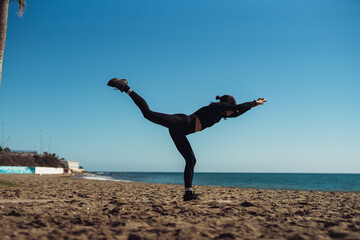 a girl doing exercises on the seashore in sportswear. fitness trainer girl doing exercise. There is space for writing text.