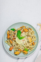 Plant based pasta with mussels, pesto and parmesan cheese. Ready to eat healthy food, served portion