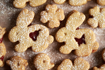 Linzer cookies in the shape of Easter bunnies filled with strawberry marmalade and dusted with sugar