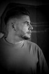 portrait of a young man with a beard in black and white