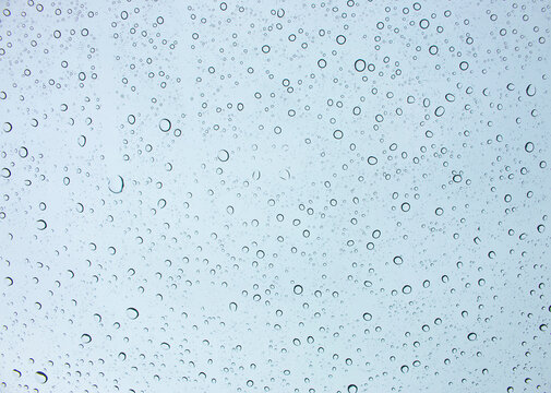 The background of rain drops on the car windshield is the sky.