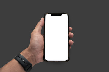 Man holding smartphone with blank screen, close-up of hands. Space for text.