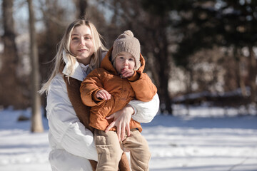 Happy mother and children at walk in park. Happy family playing outdoors in cold weather. Family,...
