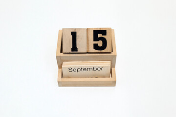 15th of September wooden perpetual calendar. Shot close up isolated on a white background
