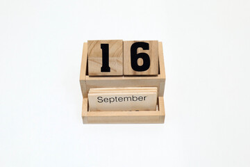 16th of September wooden perpetual calendar. Shot close up isolated on a white background