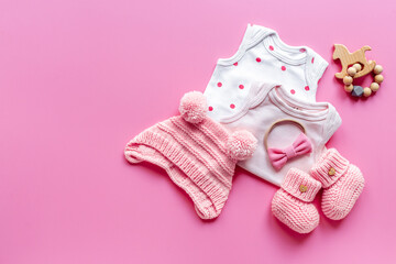 Obraz na płótnie Canvas Flat lay of pink baby clothing and accessories. Kids bodysuit and shoes flat lay