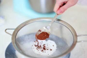  spoon of cocoa added to flour, healthy home baking concept