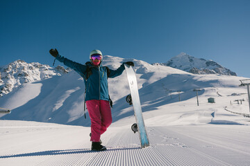 Female snowboarder on Snow trail from ratrak preparation, freshly groomed ski slope in high...