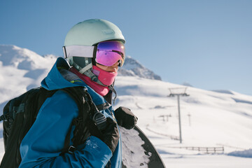 Fototapeta na wymiar Female snowboarder using walkie-talkie in high mountains, extreme winter sport outdoor